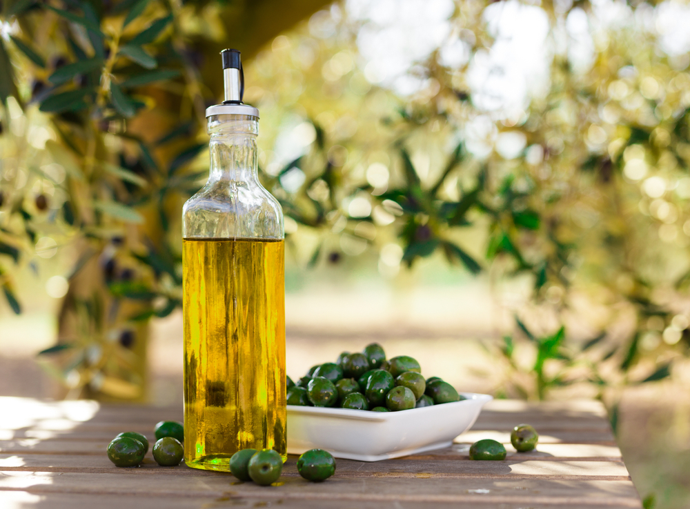 Extra virgin olive oil bottle on wooden table
